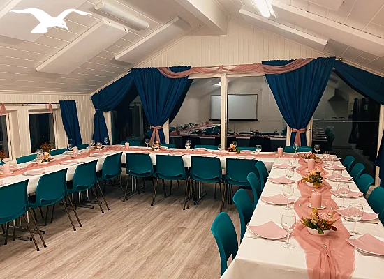 Banquet facilities in pink at Hindrum Fjordsenter in Norway at night