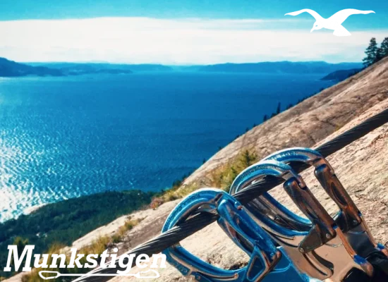 The top of Munkstigen Via Ferrata carbines with fjord view at Hindrum Fjordsenter in Norway on sunny day