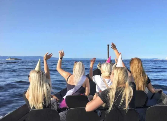 Trondheim by boat on the ocean people taking pictures